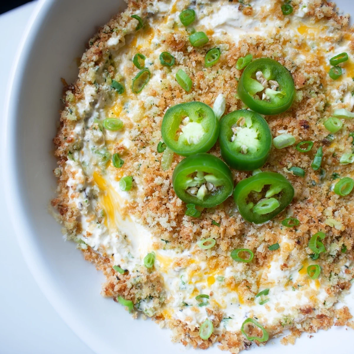 Spicy, cheesy Super Bowl Jalapeno Popper Dip with golden panko topping, ready to scoop and perfect for sharing.
