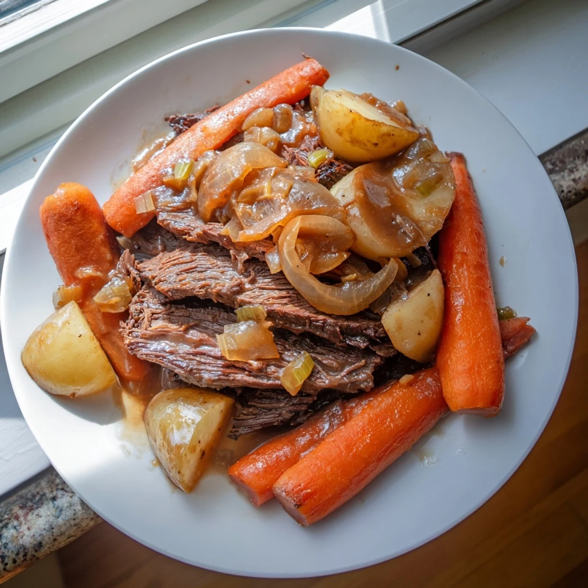 A rustic Slow Cooker Pot Roast with Carrots served over creamy mashed potatoes in a cozy kitchen setting.