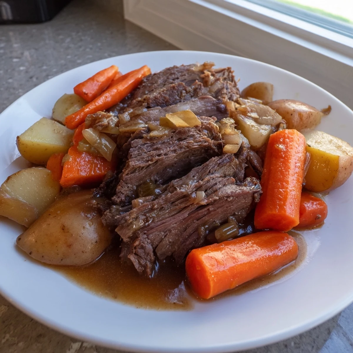Close-up of juicy Slow Cooker Pot Roast with Carrots drizzled with savory gravy, garnished with fresh thyme sprigs.