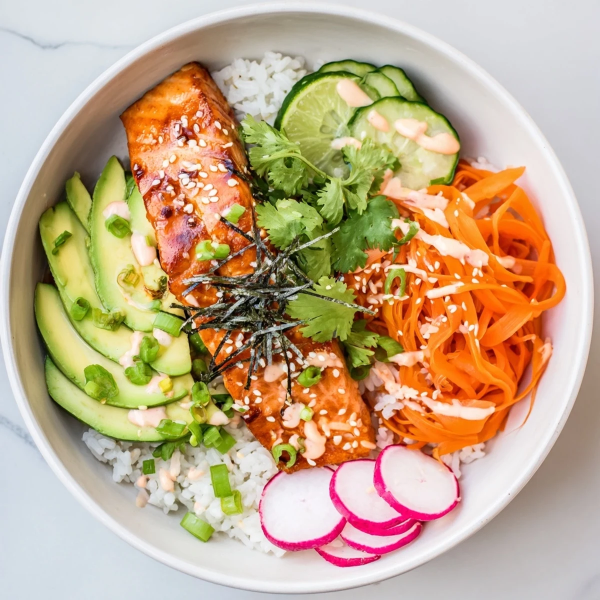 Fluffy jasmine rice and teriyaki salmon bowl topped with vibrant pickled carrots and zesty sriracha mayo. 
