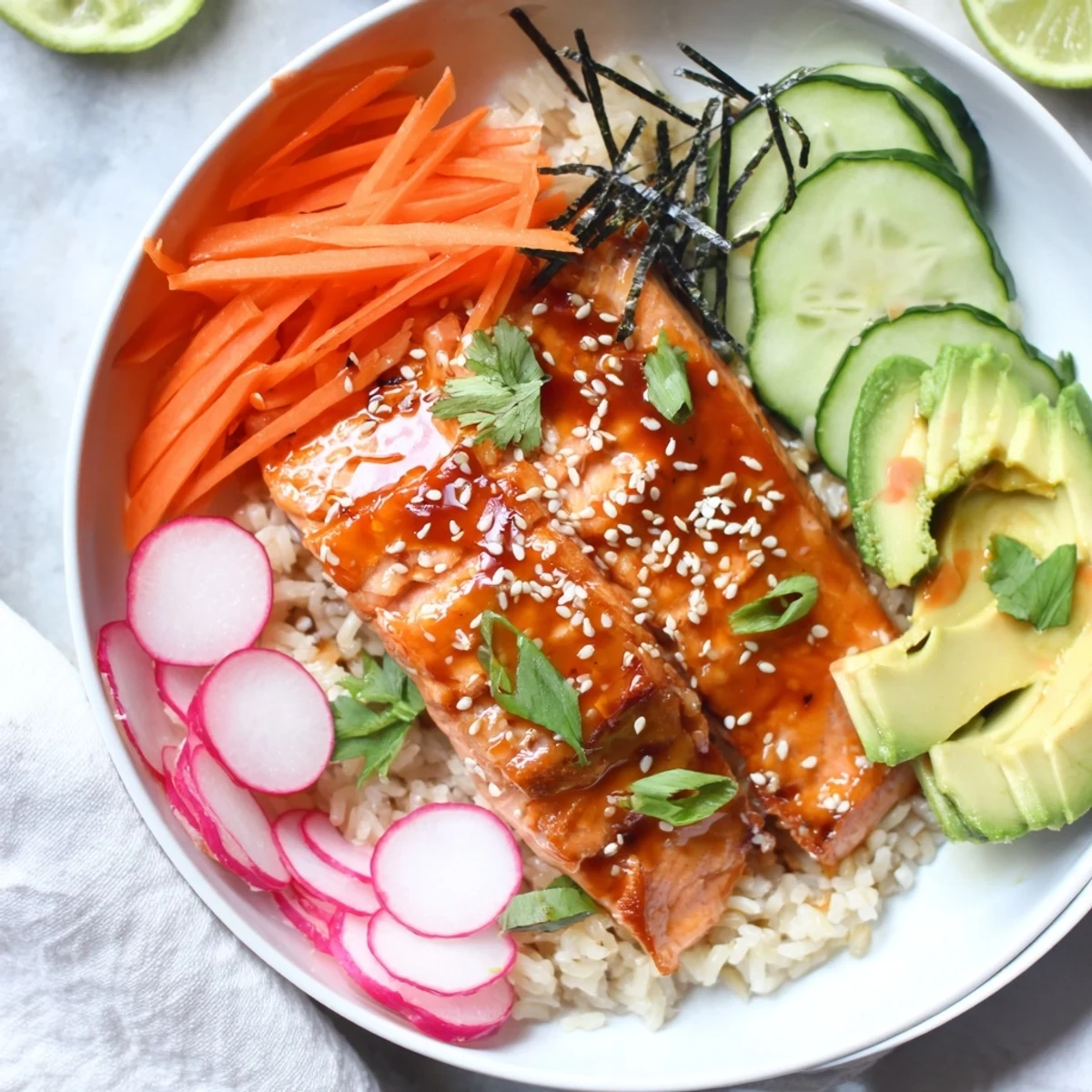 Fusion taco-style teriyaki salmon rice bowl garnished with fresh cilantro, sesame seeds, and nori strips.