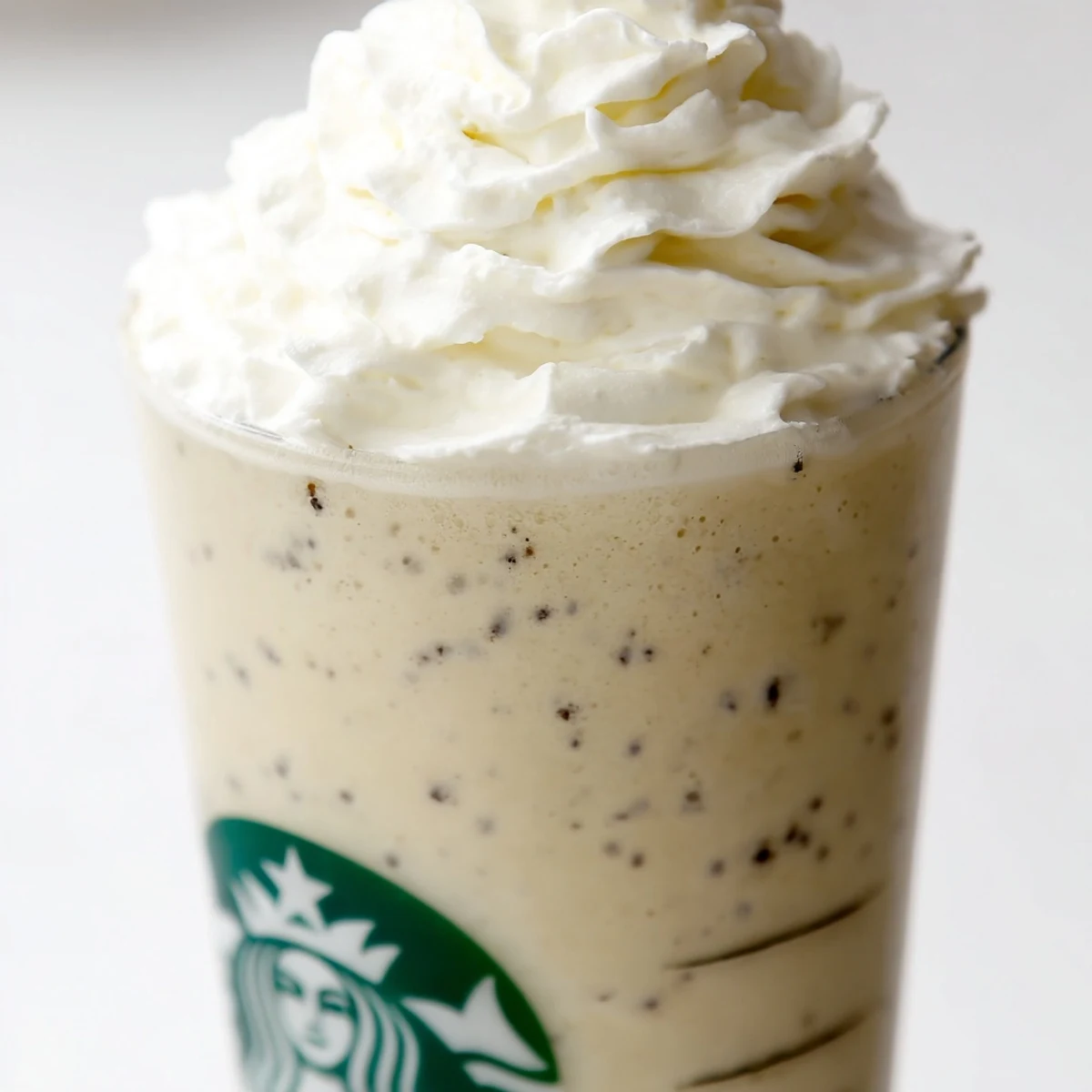 A refreshing Starbucks Vanilla Bean Frappuccino in a tall glass, ready to serve with a straw.