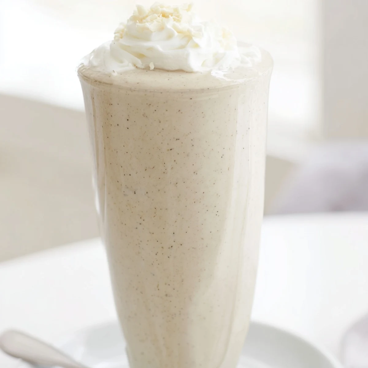 A refreshing Vanilla Bean Frappuccino served with a straw, perfect for an afternoon coffeehouse treat.