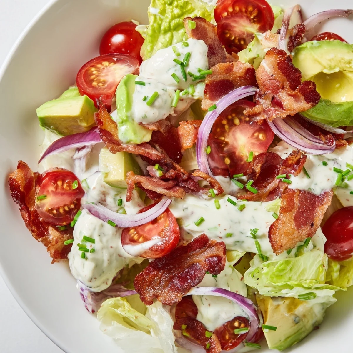 Serve Crispy Bacon Keto BLT Salad with a drizzle of keto dressing and chives for a low-carb lunch.