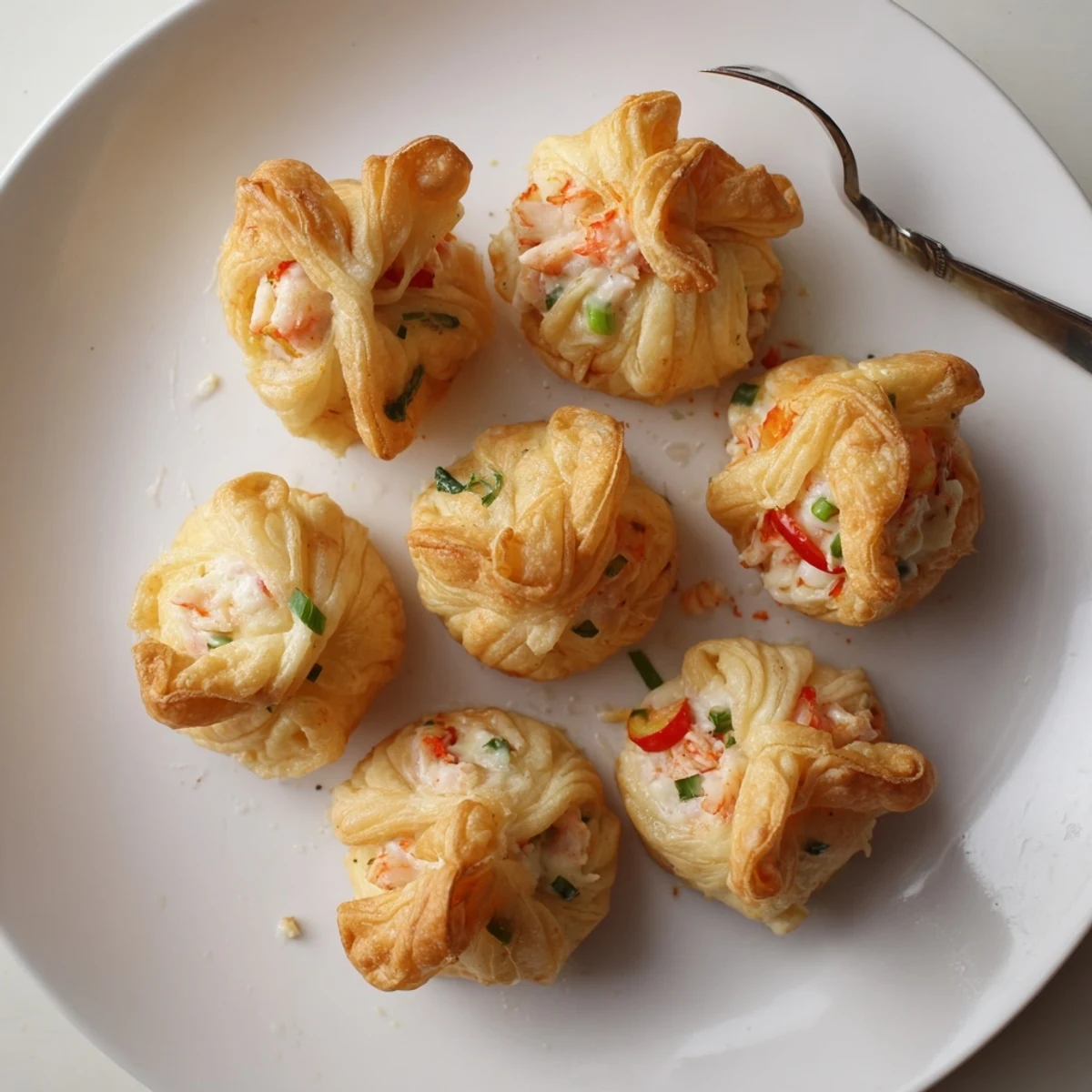 Warm Cheesy Seafood Tortilla Bombs served on a platter with lemon wedges for squeezing.