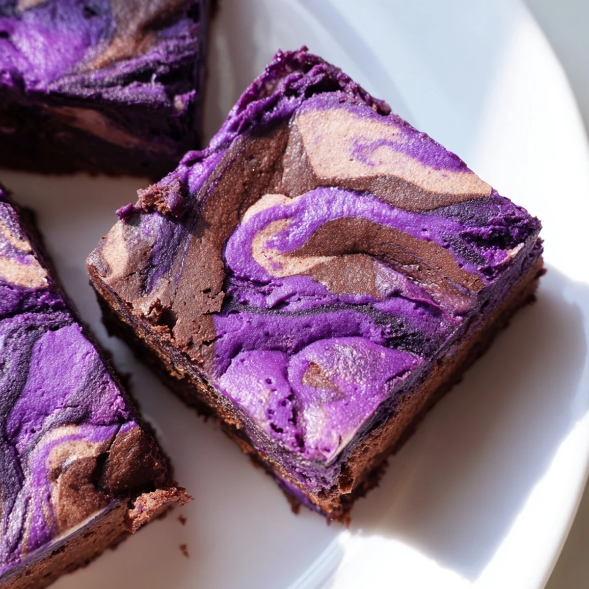 Freshly baked ube brownies featuring a crackled top and chocolate ripple design
