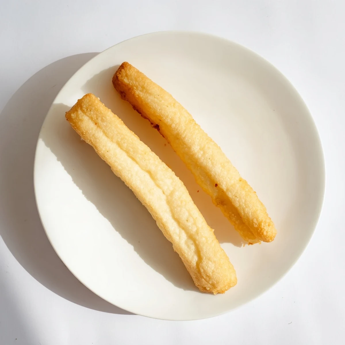 Fluffy hollow inside of Youtiao Chinese breakfast bread shown in cross section slice