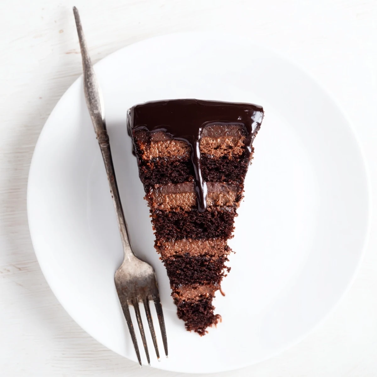 Decadent layered dark chocolate mousse cake featuring velvety mousse and moist sponge