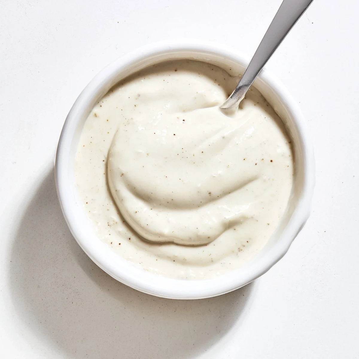 Creamy white chicken shawarma garlic sauce drizzled generously over spiced grilled meat strips