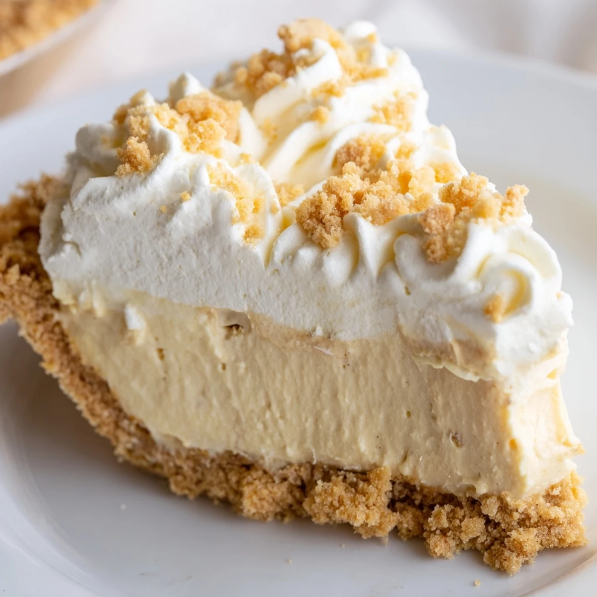 Creamy Old Fashioned Amish Peanut Butter Dream Pie topped with fluffy whipped cream and golden crumbs