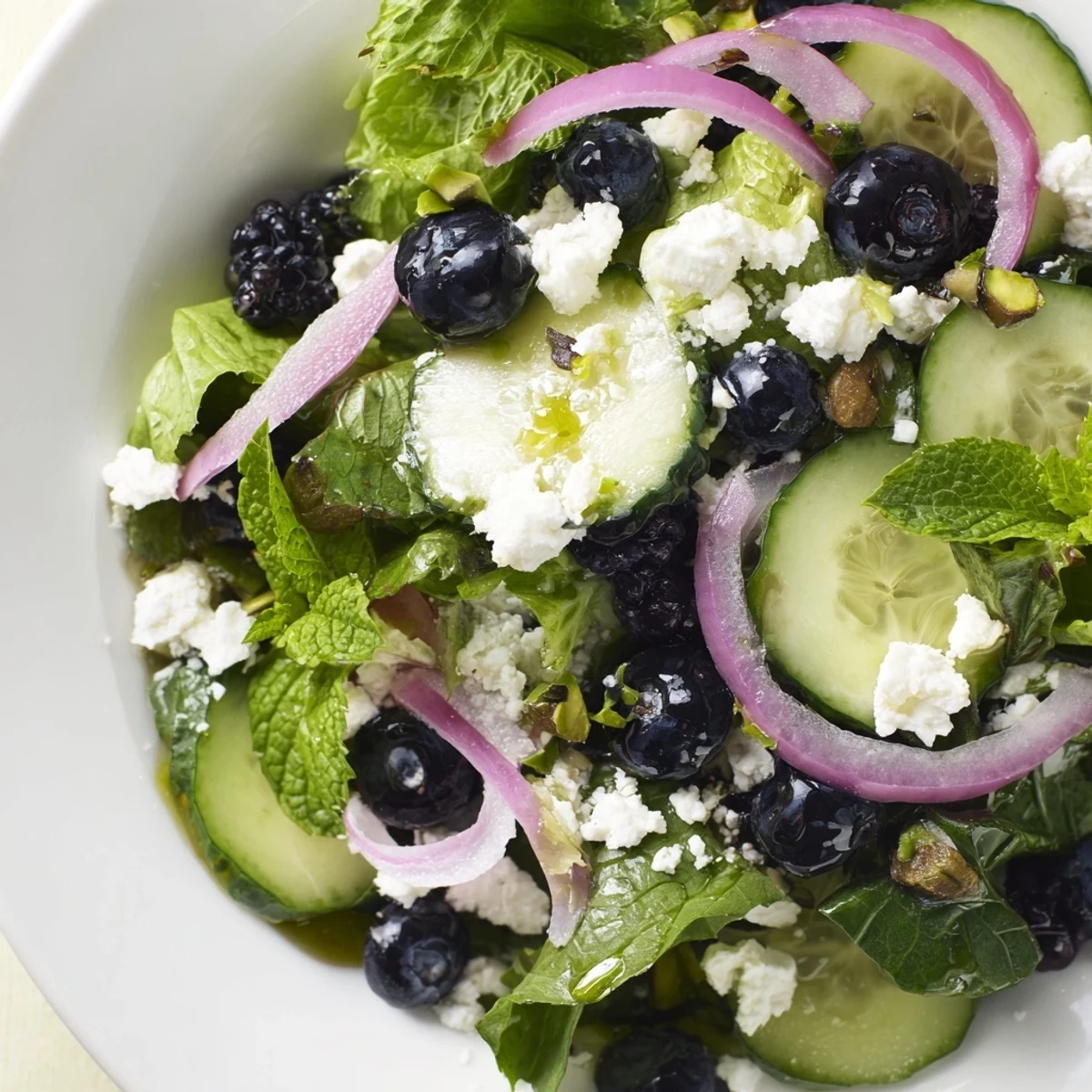 Blueberry Pistachio Spring Salad featuring vibrant greens, juicy berries, and crunchy chopped nuts