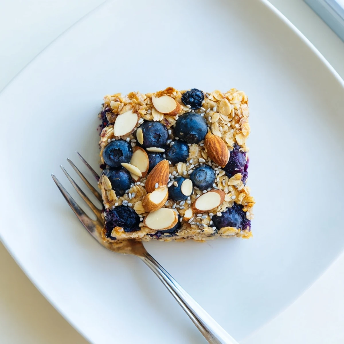 Golden high protein lemon blueberry breakfast bake with juicy berries and almonds sprinkled on top