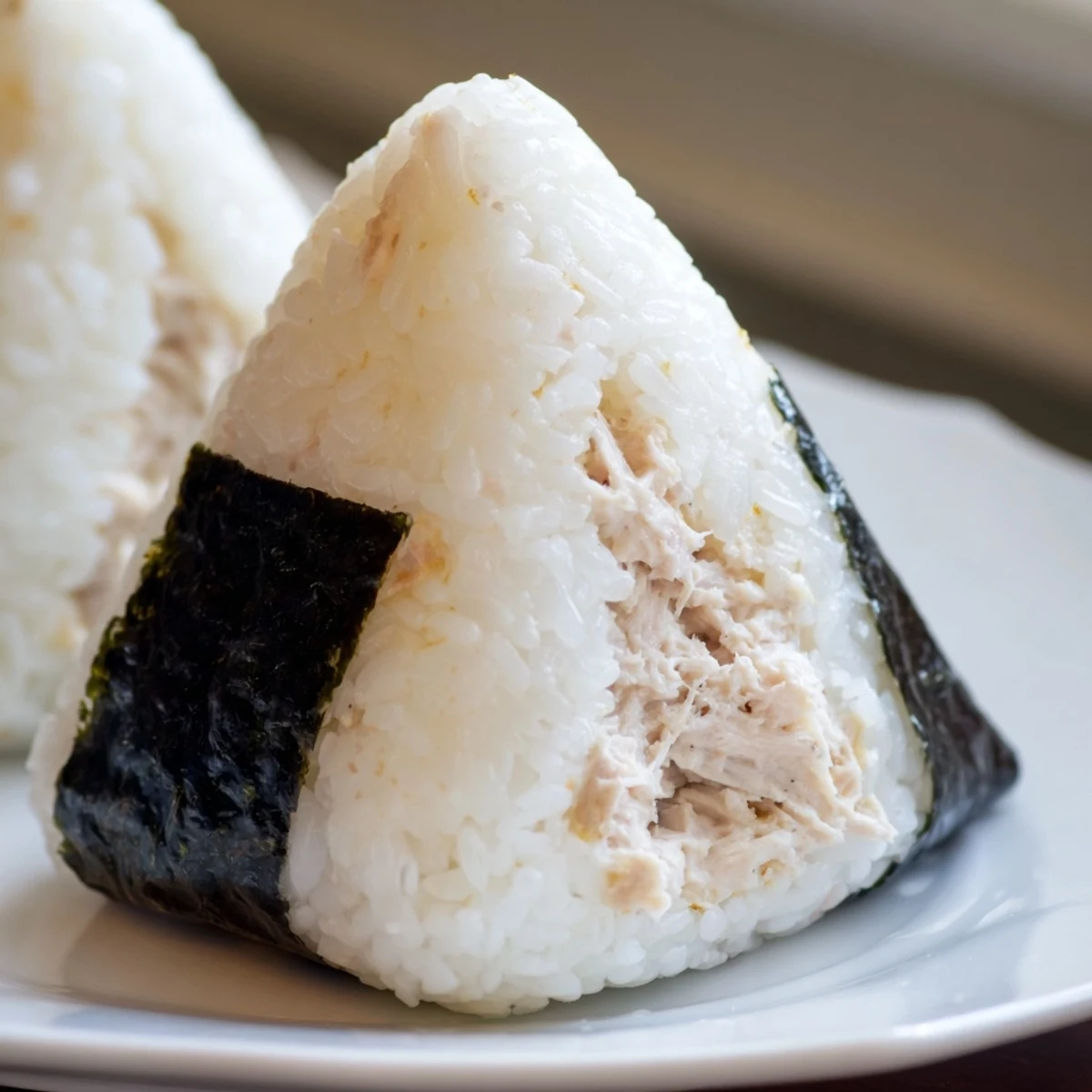 Classic tuna mayo onigiri rice balls neatly arranged with seaweed wraps for portable snacking
