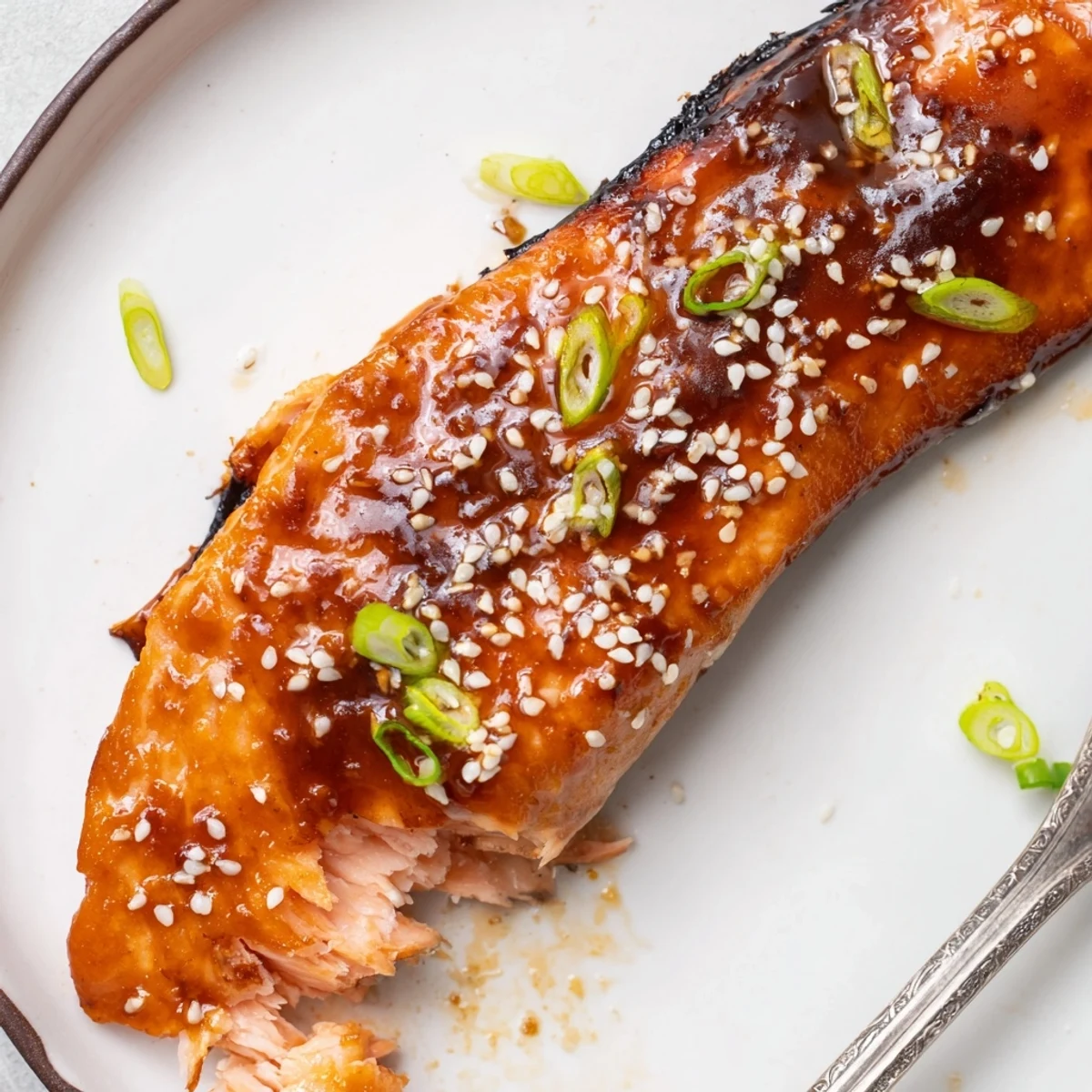 Sticky sweet-savory glazed Gluten Free Teriyaki Salmon Recipe topped with sliced spring onions