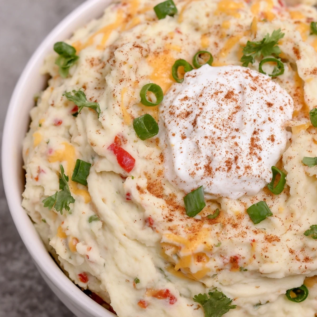 Spicy Tex Mex Mashed Potatoes served steaming in a bowl with colorful bell pepper bits