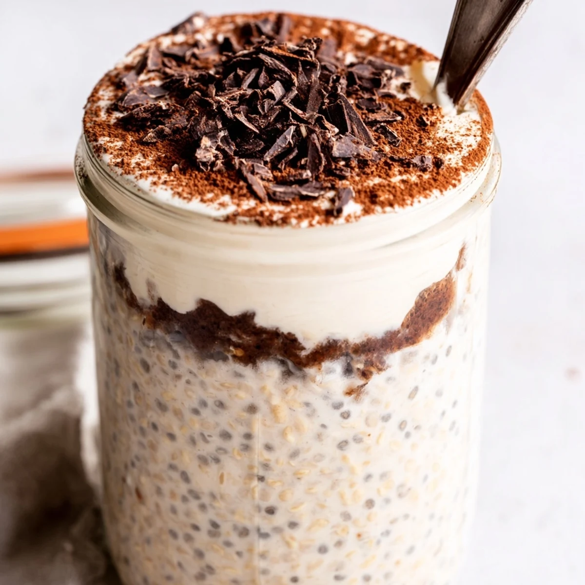 Coffee-infused tiramisu overnight oats in glass jars ready for a decadent breakfast